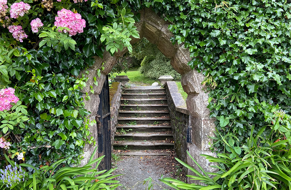 An archway inviting further exploration and entry into a verdant garden